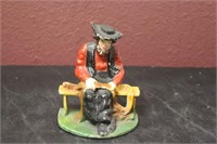 A Cast Iron Sitting Amish Man