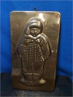 Copper chocolate mold of a boy dressed for