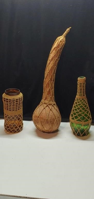 Two vintage bottles and a gourd covered in