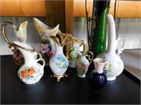 Nine pitcher style vases, several hand painted: