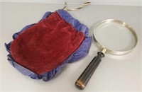 Large antique magnifying glass with padded holder