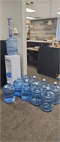 Water cooler with four full bottles of water