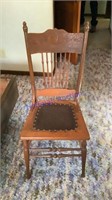 Pressed leather seat chair. One leg needs glued.