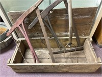 Old wood box with two bucksaw and long handled