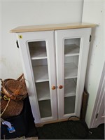 Wooden cabinet with glass inlayed doors