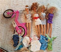 4 Barbie dolls motorbike & a few clothes