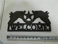 Cast iron "Welcome" sign.