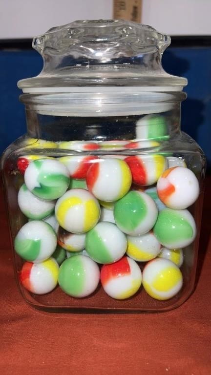 Approximately 64 shooter marbles and jar with lid