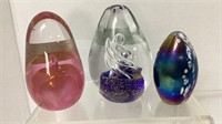 (3) Art glass oval shaped paper weights- one is