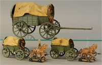 THREE ELASTOLIN HORSE DRAWN WAGONS