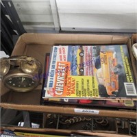 Car magazines, old alarm clock