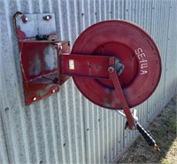 Power washer hose reel, hose is weathered