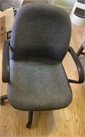 Gray upholstered office chair on five caster
