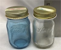 F11) TWO SMALL OLD SMOKEY GLASS JARS WITH LIDS
