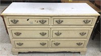 Cream colored dresser measuring 50” across 17.5”