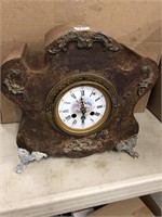 Antique iron clock case that someone has put a