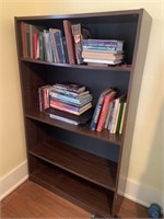 Pressboard bookcase with assortment of books