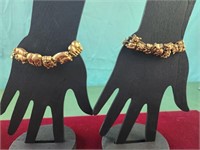 Two goldtone pig bracelets