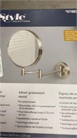 Wall mounted magnifying mirror