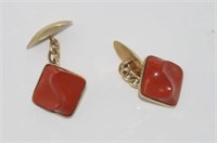 Gold cufflinks marked 14K set with red stone
