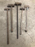 Antique sledgehammers and one ax.