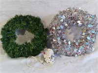 F7)  2 Christmas wreaths. The green has built in