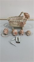 Bisque and porcelain doll pieces, wicker baby