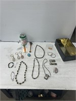 Tin of decorative necklaces and keychain