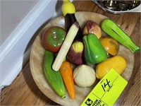Bowl with artificial fruit and vegetables appear t