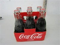 6 pack Christmas coca cola bottles.