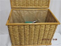 Wicker trunk filled with ski rope, fishing lures,