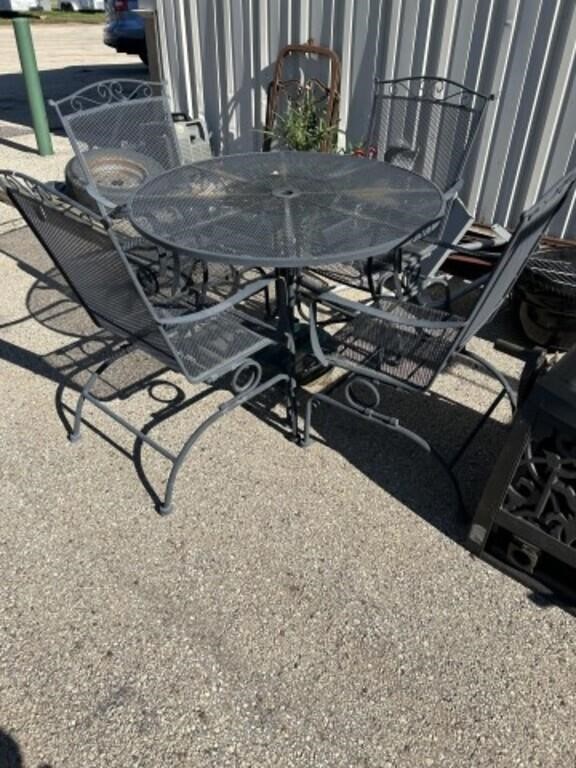 Metal wrought iron table and 4 rocking chairs