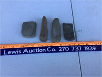 4 smooth stones, possibly sharpening instruments.