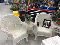 Two white wicker chairs with side table