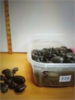Small container of black rocks