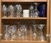 Assorted glassware in cabinet