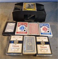 Unopened playing cards and card shuffler