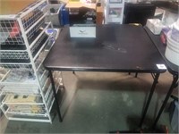 Black folding table damaged