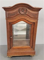 Antique table top curio cabinet with brass feet -