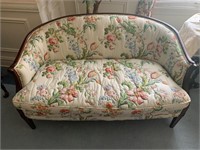 Floral settee with wood trim and legs