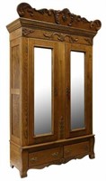 AMERICAN CARVED OAK MIRRORED TWO-DOOR ARMOIRE