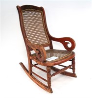 Child's red Lincoln-style rocker with caned seat