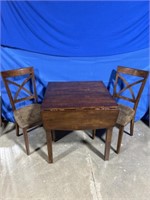 Wood folding dining room table with 2 chairs.