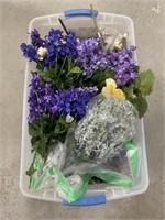 Artificial flowers and greenery in a tote with a