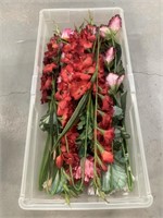 Artificial flowers and greenery in a Rubbermaid