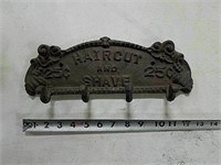 Cast iron "haircut and shave" coat hook.