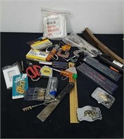 Vintage belt buckles, cup hooks, tape measures,