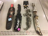 4 knives in holster and batman figure.
