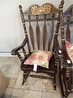 One wooden rocker with pillow