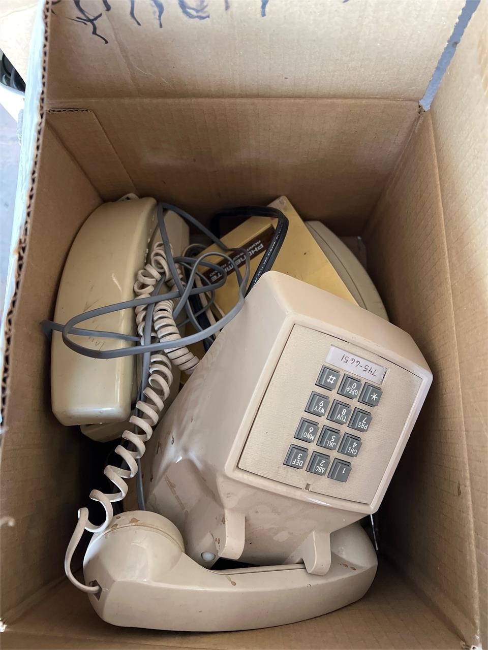 Box of vintage landline phones